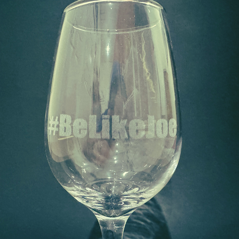 Wine Glass with #BeLikeJoe engraved on it.